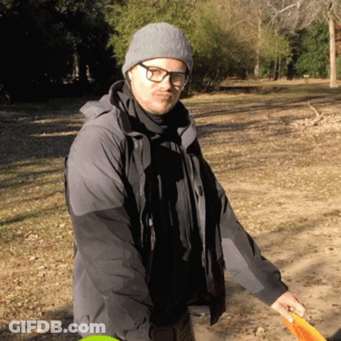 Man With Glasses And Beanie Holding Frisbee GIF