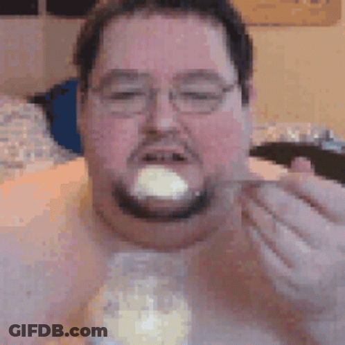 Man With Glasses And Beard Eating From Jar With Spoon GIF