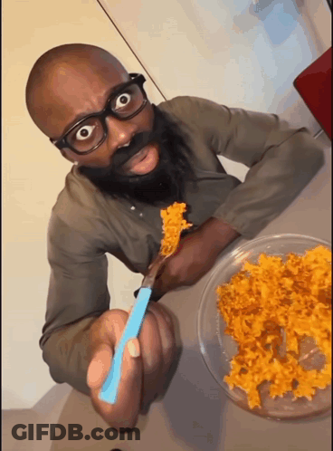 Man With Glasses And Beard Eating With Blue Spoon GIF