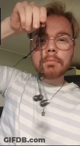 Man With Glasses And Beard Holding Earbuds GIF