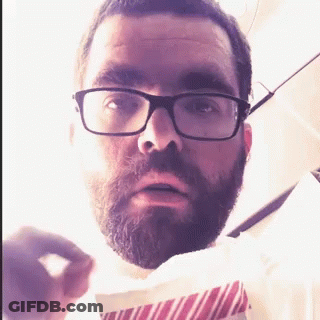 Man With Glasses And Beard Holding Paper GIF