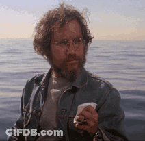 Man With Glasses And Beard Holding Paper GIF