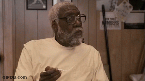 Man With Glasses And Beard Holding Spoon In Front Of Numbers Sign GIF