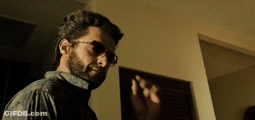 Man With Glasses And Beard In Dark Room GIF