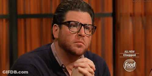 Man With Glasses And Beard In Front Of Food Network Sign GIF