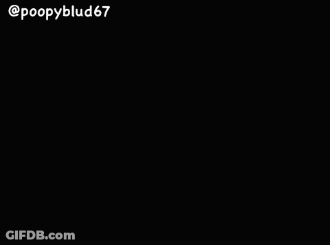 Man With Glasses And Beard In Front Of Red Bag GIF