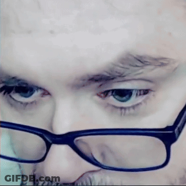 Man With Glasses And Beard Looking At Camera GIF