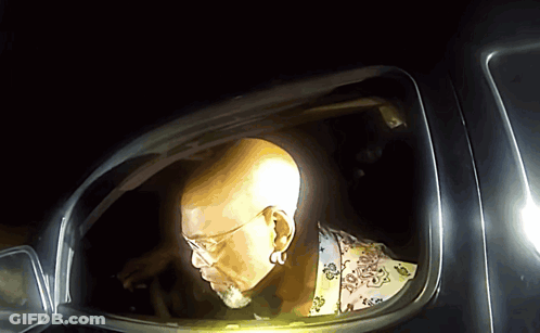 Man With Glasses And Beard Looking Out Car Window GIF