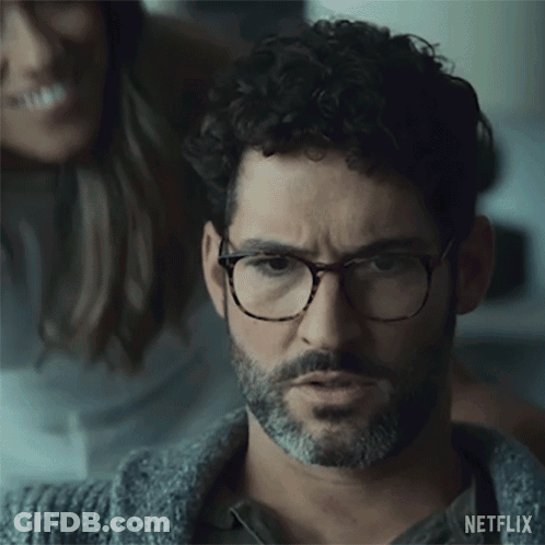Man With Glasses And Beard Looking With Woman In Background GIF