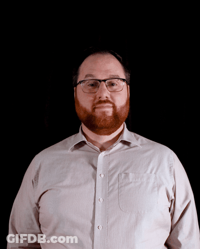 Man With Glasses And Beard Looks At Camera GIF