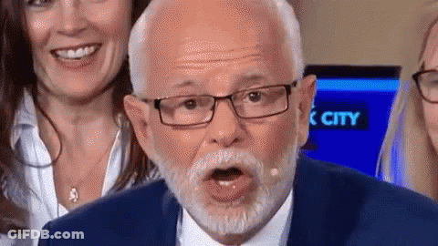 Man With Glasses And Beard Making Funny Face Behind Two Women Smiling GIF