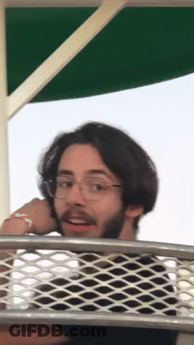 Man With Glasses And Beard Over Wire Fence GIF