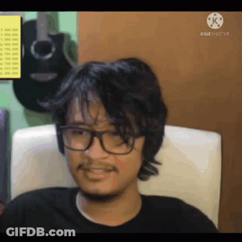 Man With Glasses And Beard Sitting GIF