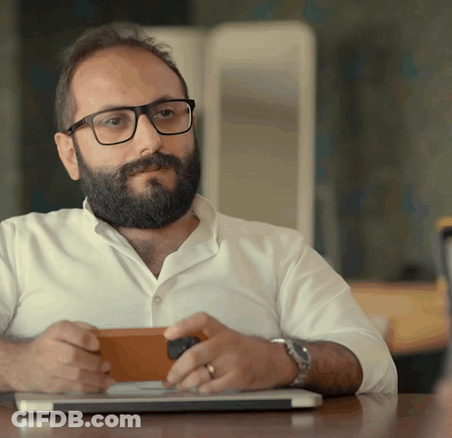 Man With Glasses And Beard Sitting At Laptop GIF