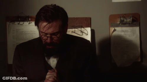 Man With Glasses And Beard Sitting By Clipboard Number 2 GIF