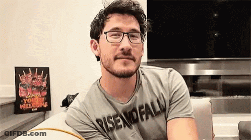 Man With Glasses And Beard Sitting On Couch In Front Of TV GIF