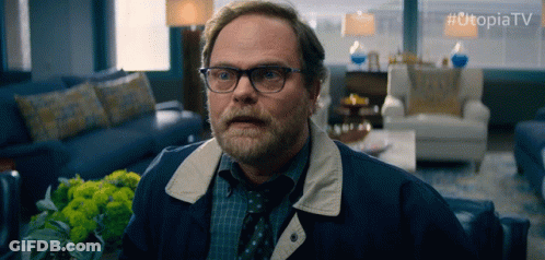 Man With Glasses And Beard Sitting With Utopiatv GIF