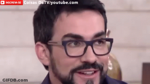 Man With Glasses And Beard Smiling In Front Of YouTube Banner GIF