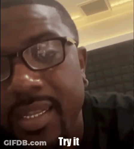 Man With Glasses And Beard Smiling Says Try It GIF