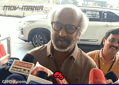 Man With Glasses And Beard Surrounded By Moviemania Microphones GIF
