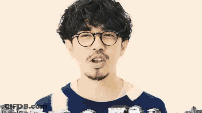 Man With Glasses And Beard Surrounded By Small Houses GIF