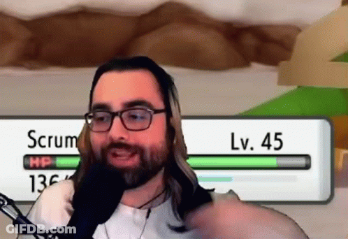 Man With Glasses And Beard Talking Into Microphone In Front Of Scrum LV 45 Screen GIF