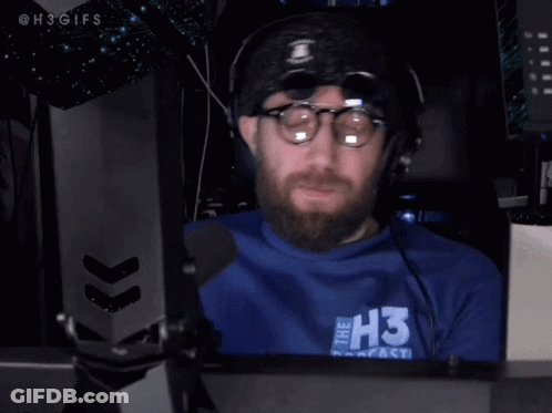 Man With Glasses And Beard Wearing Headphones And Blue Shirt GIF
