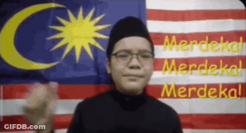 Man With Glasses And Black Hat By Malaysian Flag GIF