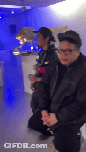 Man With Glasses And Black Hat Kneeling GIF