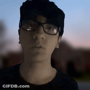 Man With Glasses And Black Shirt Looking At Camera GIF