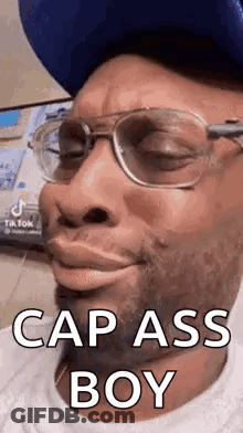 Man With Glasses And Blue Hat Making Funny Face GIF