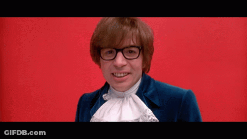 Man With Glasses And Blue Jacket Smiling On Red Background GIF