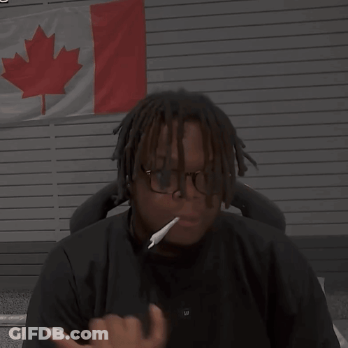 Man With Glasses And Cigarette In Front Of Canadian Flag GIF