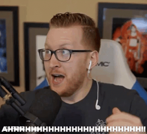 Man With Glasses And Ear Buds Talking Into Microphone Saying Ahhhh GIF