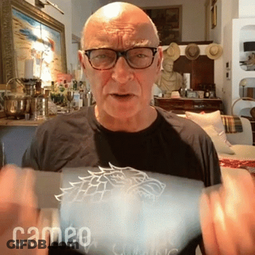 Man With Glasses And Game Of Thrones T-Shirt Holding Something GIF