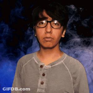 Man With Glasses And Gray Shirt In Front Of Blue Background GIF