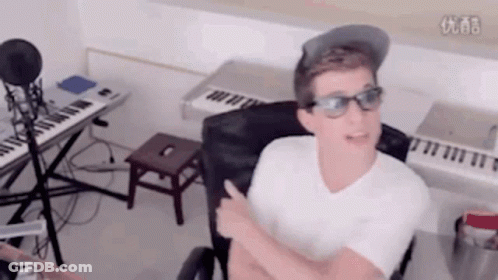 Man With Glasses And Hat At Microphone And Keyboard GIF