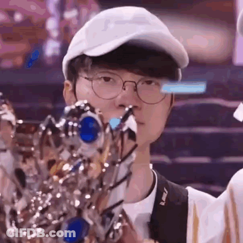 Man With Glasses And Hat Holding Trophy GIF