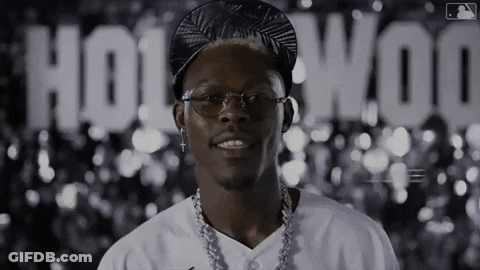 Man With Glasses And Hat In Front Of Hollywood Sign GIF