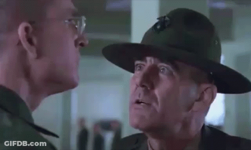 Man With Glasses And Hat Looking At Another Man GIF