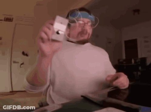Man With Glasses And Headband Holding Camera GIF