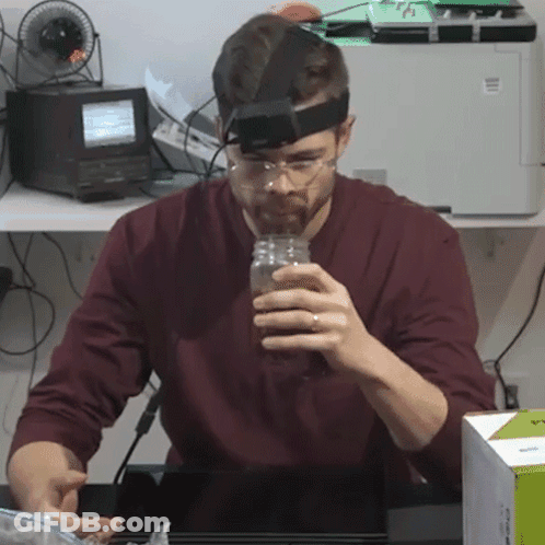 Man With Glasses And Headband Holding Jar GIF