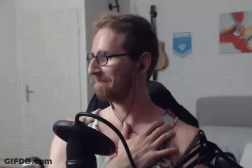 Man With Glasses And Headphones Holding Chest At Microphone GIF