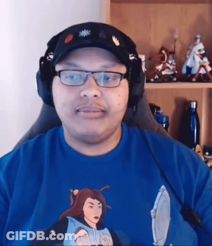Man With Glasses And Headphones In Front Of Shelf With Figurines GIF