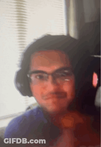 Man With Glasses And Headphones Looking At Camera GIF