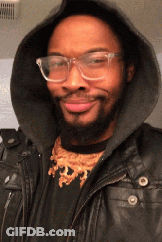 Man With Glasses And Hooded Jacket Smiling GIF