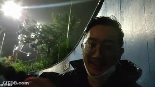 Man With Glasses And Mask Smiling Near 1282 Wall GIF