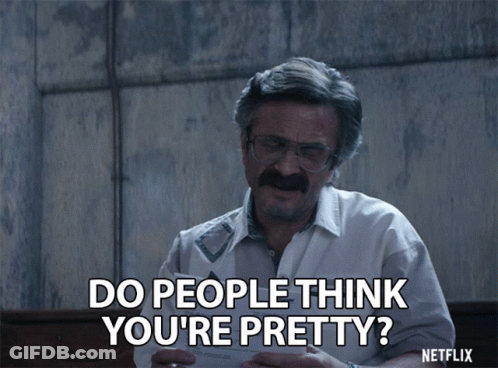 Man With Glasses And Mustache Holding Paper Do People Think You're Pretty GIF