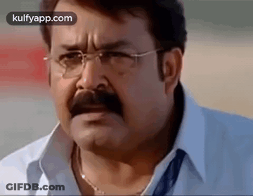 Man With Glasses And Mustache Looking At Camera GIF