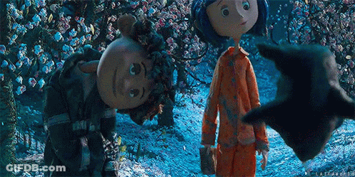 Man With Glasses And Mustache Next To Two Dolls GIF